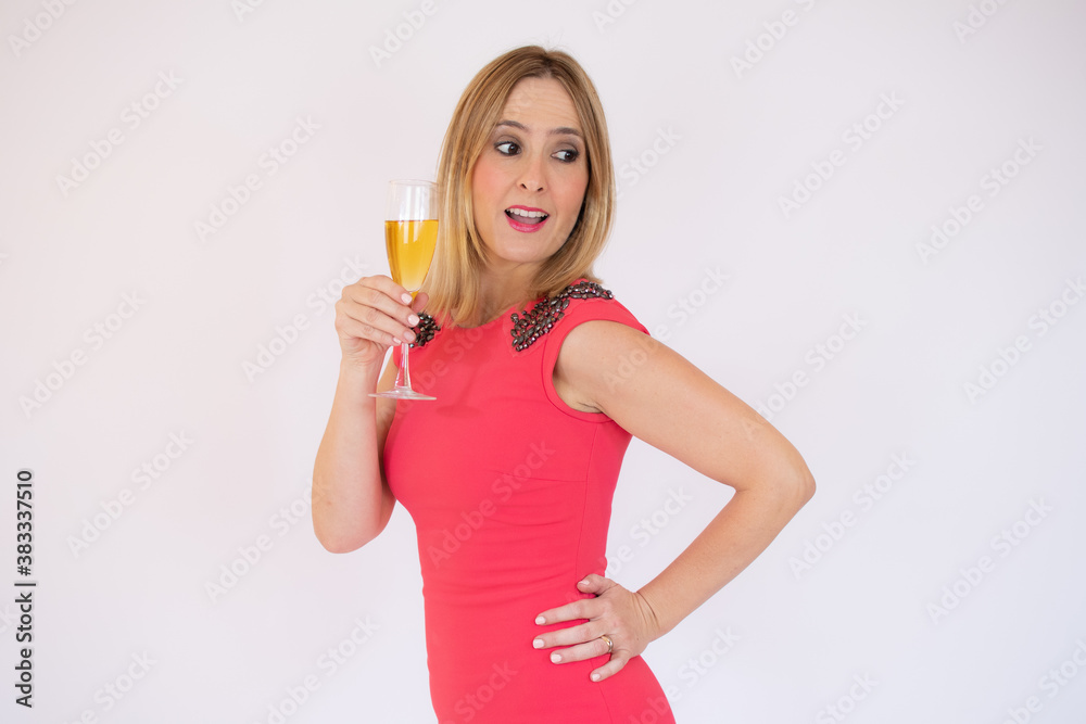 Young celebrating woman red dress. Beautiful model portrait isolated over studio background hold wine glass. Young celebrating woman red dress. Beautiful model portrait isolated over studio background hold wine glass.