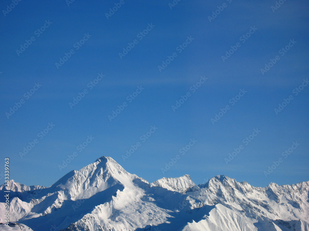 Blauer Himmel und schneebedeckte Berggipfel als 
Hintergrund