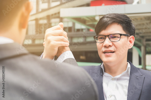 Businessman shaking hands and hold hands finishing meeting or deal successful