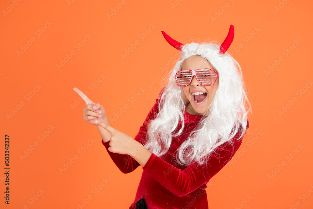 just look here. smiling child in devil horns and party glasses. kid has long white hair wig. childhood happiness. teen girl ready to celebrate costume party. funny red imp horns. happy halloween just look here. smiling child in devil horns and party glasses. kid has long white hair wig. childhood happiness. teen girl ready to celebrate costume party. funny red imp horns. happy halloween