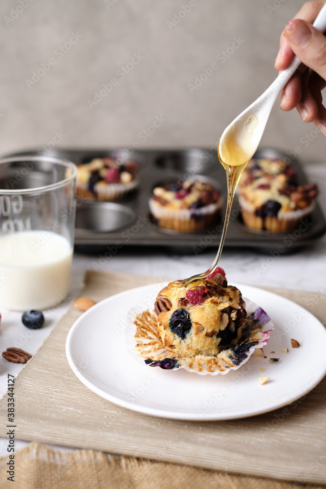 mixed berry low carb Keto Diet muffin with almond and nut. set on cafe table.