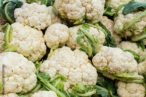 Fresh organic cauliflowers on the farmers market. Close-up cauliflower background. Healthy vegan food.