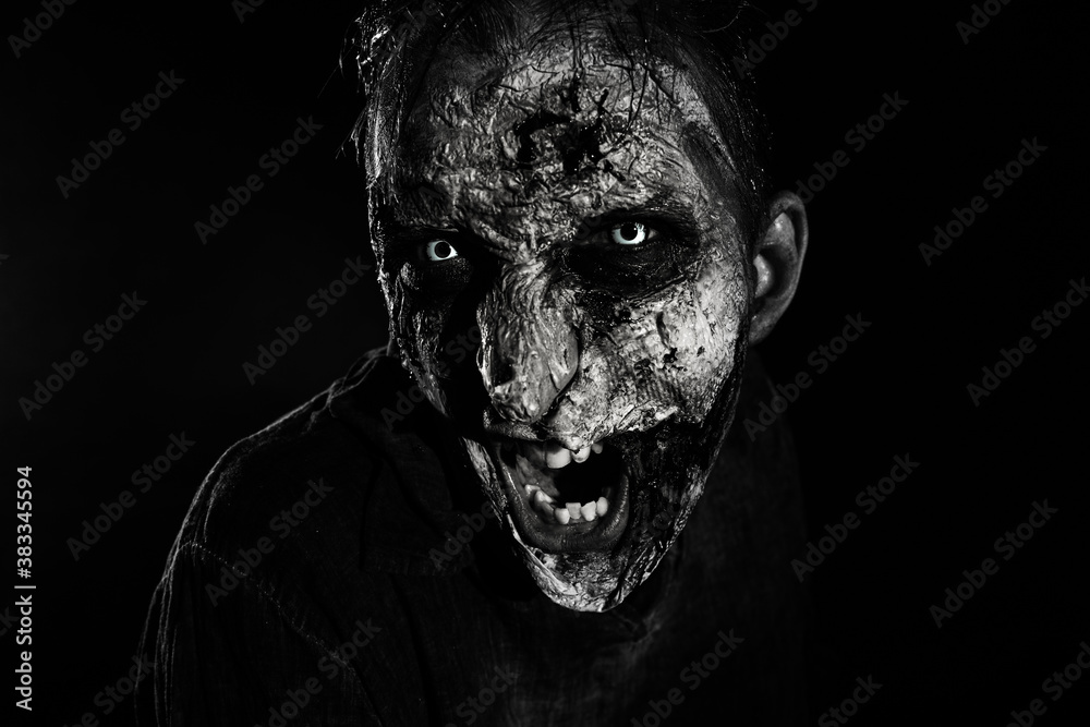 Scary zombie on dark background, black and white effect. Halloween monster Scary zombie on dark background, black and white effect. Halloween monster