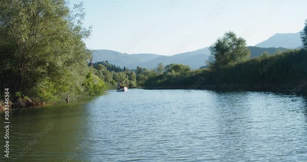 A group of tourists are sailing on a boat on the river on a summer evening. View of greenery and mountains. Boat trip. High quality 4k footage A group of tourists are sailing on a boat on the river on a summer evening. View of greenery and mountains. Boat trip. High quality 4k footage