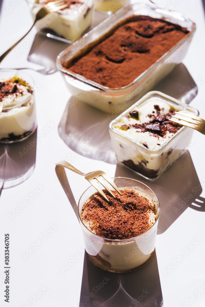 Tiramisu in different shape, various form of serving tiramisu, on glasses, classic, and as a round cake, Tiramisu in different shape, various form of serving tiramisu, on glasses, classic, and as a round cake,