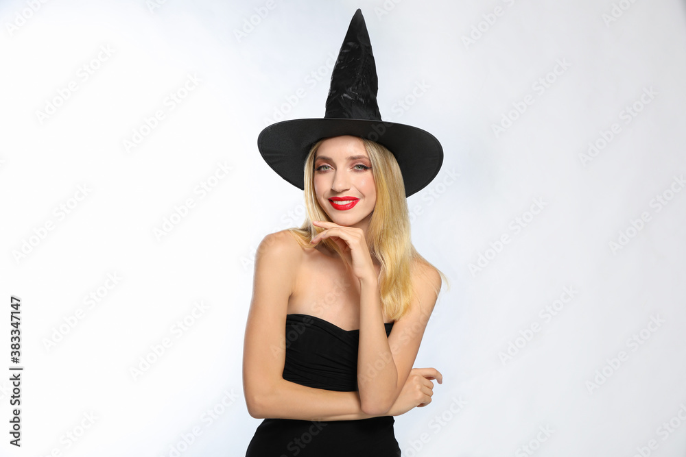 Beautiful woman in witch costume on white background. Halloween party Beautiful woman in witch costume on white background. Halloween party