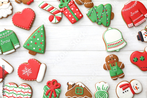 Frame of different delicious Christmas cookies on white wooden table, flat lay. Space for text