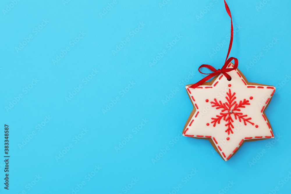 Snowflake shaped Christmas cookie on light blue background, top view. Space for text Snowflake shaped Christmas cookie on light blue background, top view. Space for text