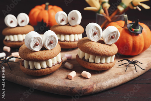 Delicious Halloween themed desserts on wooden table, closeup photo