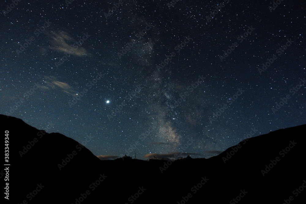 Starry sky and milky way in the mountains. Mountain village against the background of the night starry sky and the milky way. Starry sky and milky way in the mountains. Mountain village against the background of the night starry sky and the milky way.