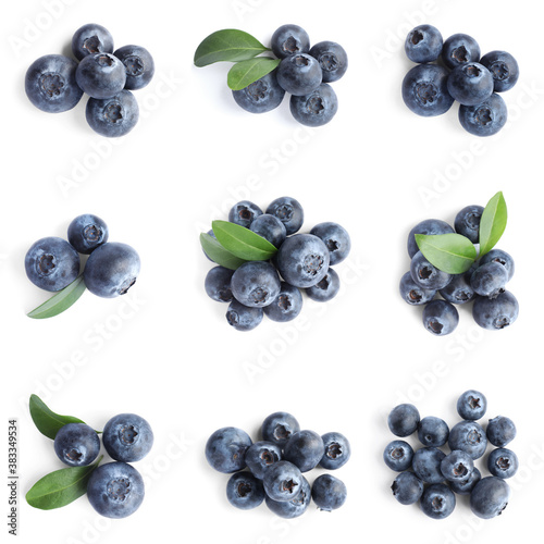 Set of fresh blueberries with green leaves on white background, top view