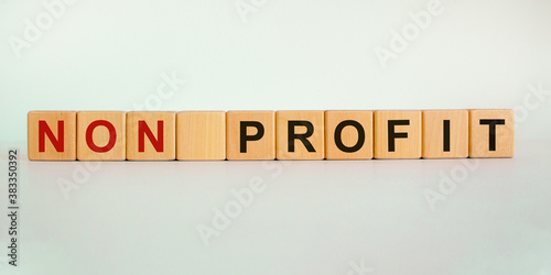 Concept words 'non profit' on wooden cubes on a beautiful white background. Business concept. Copy space.