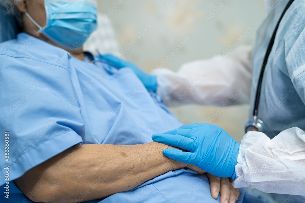 Doctor using stethoscope to checking Asian senior or elderly old lady woman patient wearing a face mask in hospital for protect infection Covid-19 Coronavirus. Doctor using stethoscope to checking Asian senior or elderly old lady woman patient wearing a face mask in hospital for protect infection Covid-19 Coronavirus.