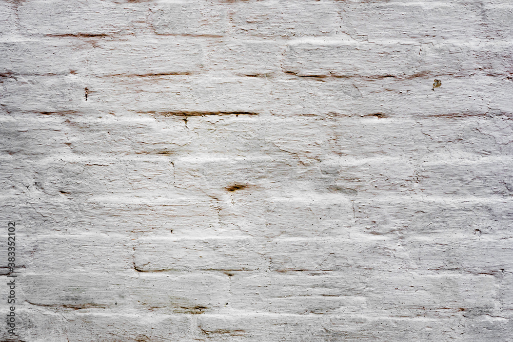 Texture of a brick wall with cracks and scratches which can be used as a background Texture of a brick wall with cracks and scratches which can be used as a background