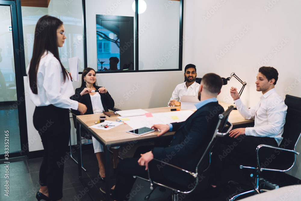 Diverse coworkers having conversation in office Diverse coworkers having conversation in office