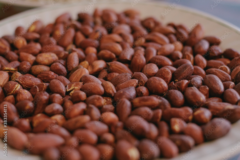Roasted peanuts in a plate. Close-up. Macro shot. Selective focus. Roasted peanuts in a plate. Close-up. Macro shot. Selective focus.