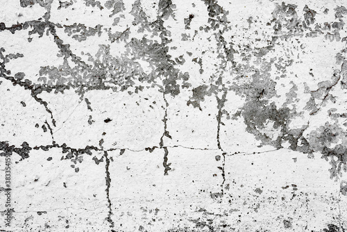 Texture of a concrete wall with cracks and scratches which can be used as a background © chernikovatv