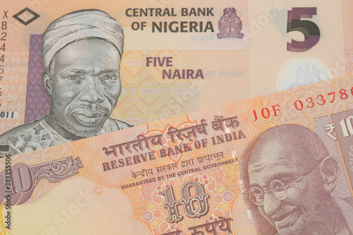 Wallpaper Mural A macro image of a orange ten rupee bill from India paired up with a orange, plastic five naira note from Nigeria.  Shot close up in macro. Torontodigital.ca