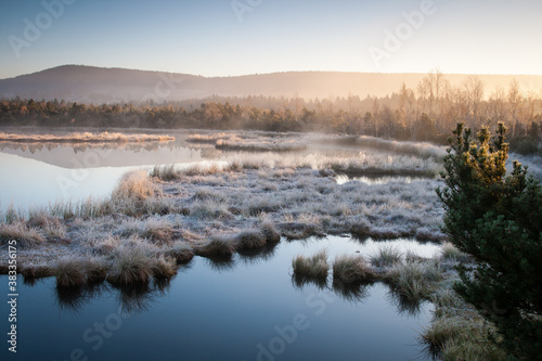 sunrise over the frozen lake, cold autumn landscape, bohemian forest