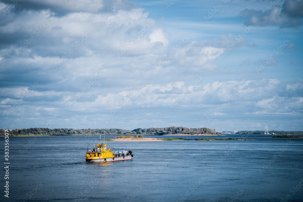 Fototapeta premium Yellow steamer, river, cold sky, Volga river
