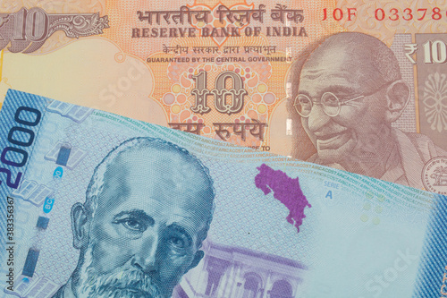 Wallpaper Mural A macro image of a orange ten rupee bill from India paired up with a colorful two thousand colones bank note from Costa Rica.  Shot close up in macro. Torontodigital.ca