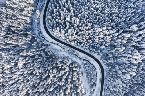 Winter chill. Natural winter landscape from air. Aerial view on the road and forest at the winter time. Forest and snow. © biletskiyevgeniy.com