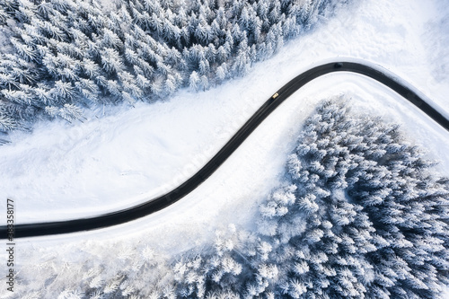 Winter chill. Natural winter landscape from air. Aerial view on the road and forest at the winter time. Forest and snow. © biletskiyevgeniy.com