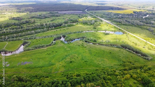 Aerial view of the Seim River (Ukraine), surrounded by trees and meadows near The palace and park complex of Kirilo Razumovsky.