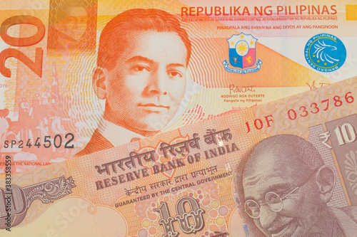 Wallpaper Mural A macro image of a orange ten rupee bill from India paired up with a orange and white twenty piso note from the Philippines.  Shot close up in macro. Torontodigital.ca