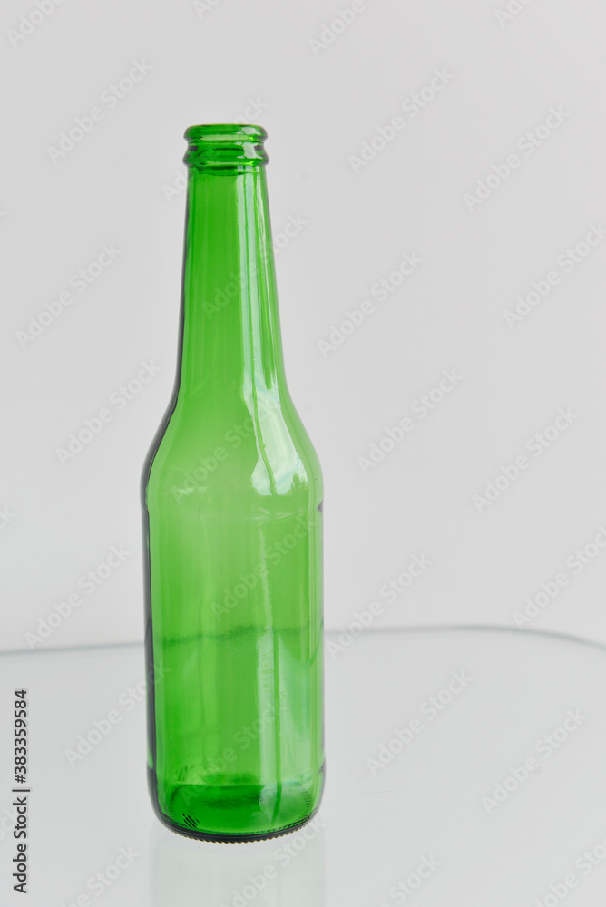 Beer bottle and glass reflections. Empty beer bottle isolated on white background. Beer bottle and glass reflections. Empty beer bottle isolated on white background.