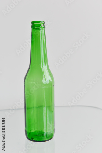 Beer bottle and glass reflections. Empty beer bottle isolated on white background.