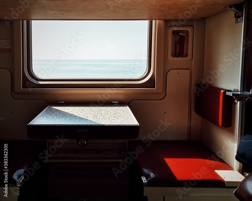 View from the window of an old train to the sea on a sunny day