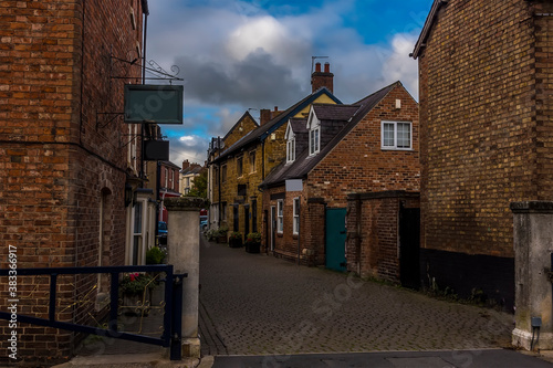 A view down a traditional quaint street in Melton Mowbray, Leicestershire, UK in the summertime photo