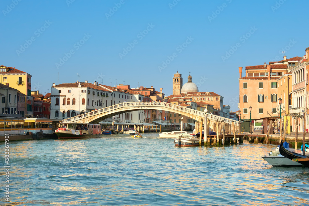 Traditional houses and foot bridge across on Grand Canal in Venice, Italy.