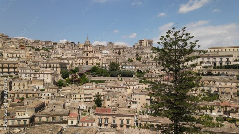 Drone flies in the direction of cathedral of Saint George in the sicilian baroque town Modica in province of Ragusa in Sicily Drone flies in the direction of cathedral of Saint George in the sicilian baroque town Modica in province of Ragusa in Sicily