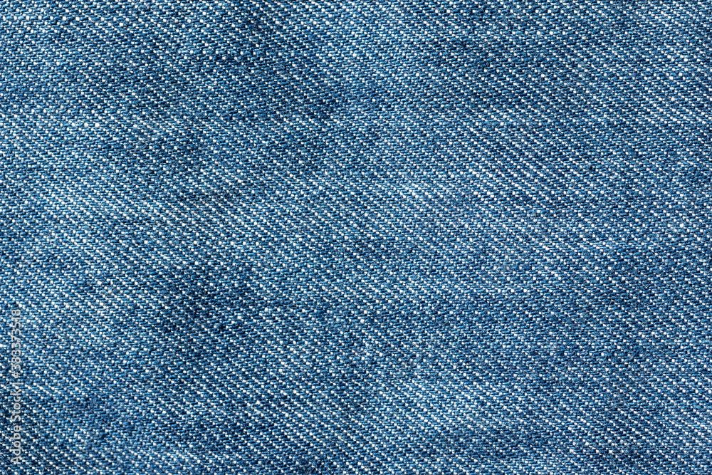 Abstract blue jeans fabric texture and background. Detail of jean textile material. Abstract blue jeans fabric texture and background. Detail of jean textile material.