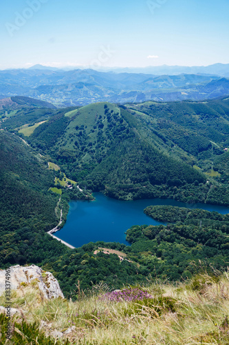 Artificial lake in a valley between green mountains