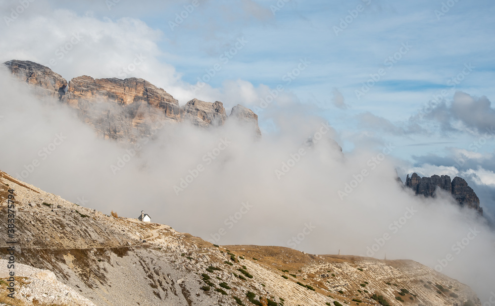 Mountain landscape with fog in autumn. Tre Cime dolomiti Italy.