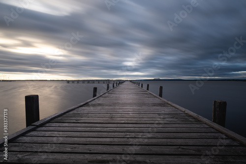 pier in the sea with cloudy sky