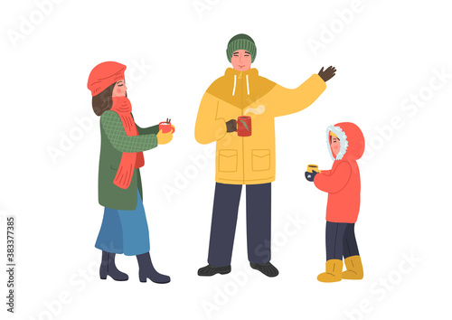 Family drink hot drinks, tea or coffee outdoors. Woman, man and girl in winter warm clothes.