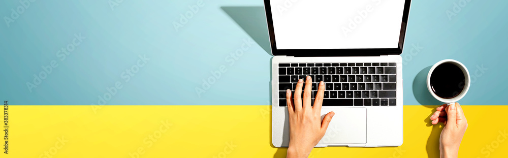 Person using a laptop computer from above Person using a laptop computer from above
