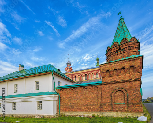 Fortified walls surrounding of Staraya Ladoga Saint Nicholas (Staroladozhsky Nikolsky) male monastery on the banks of the Volkhov river at sunny autumn day photo