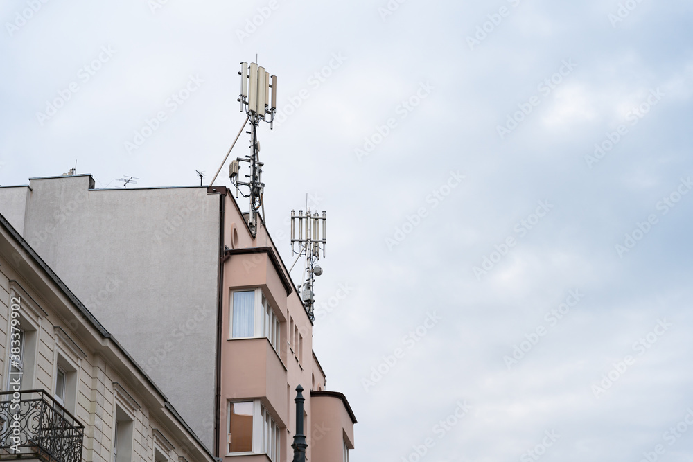 Smart cellular network 5G antennas on a residential building. Large copy space.