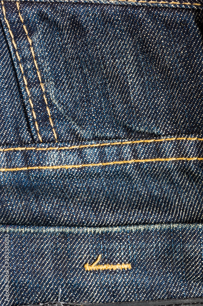 clothing items blue stonewashed faded jeans cotton fabric texture with seams, clasps, buttons and rivets, macro, close-up clothing items blue stonewashed faded jeans cotton fabric texture with seams, clasps, buttons and rivets, macro, close-up