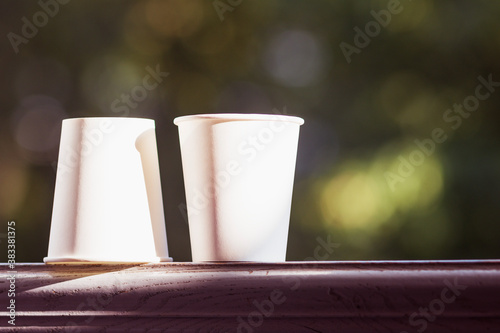 Two white disposable paper cups