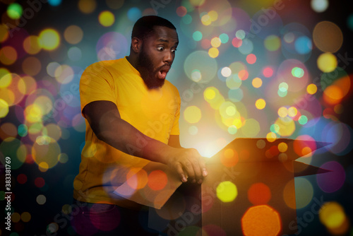 Surprised man receives Christmas gift. happy and surprised expression. photo