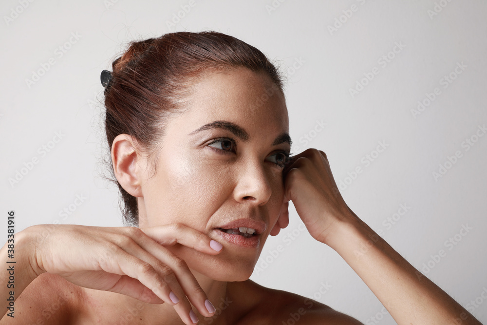Close-up of beautiful senior woman touching her perfect skin isolated over grey background. Aging process concept. Close-up of beautiful senior woman touching her perfect skin isolated over grey background. Aging process concept.