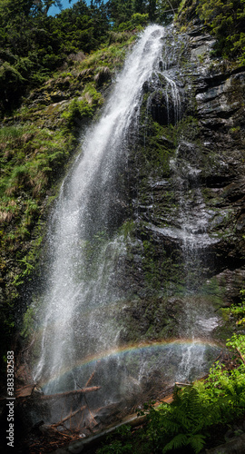 Picturesque summer Yalyn waterfall  higest waterfall in Ukrainian Carpathian Mountains  Marmaros. Beatiful rainbow in water streams and water dust. High resolution multishot stitched image.
