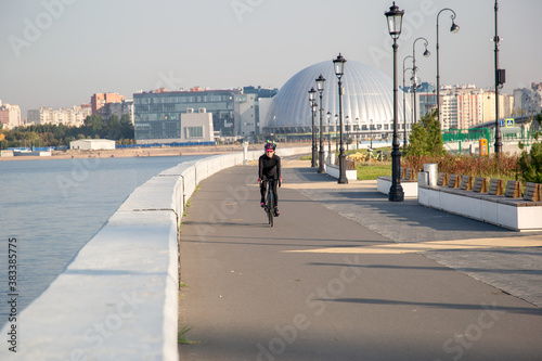 Woman rides a bike in the park. Cycling. Outdoor sports. Russia St. Petersburg.Sunrise Cycling Workout