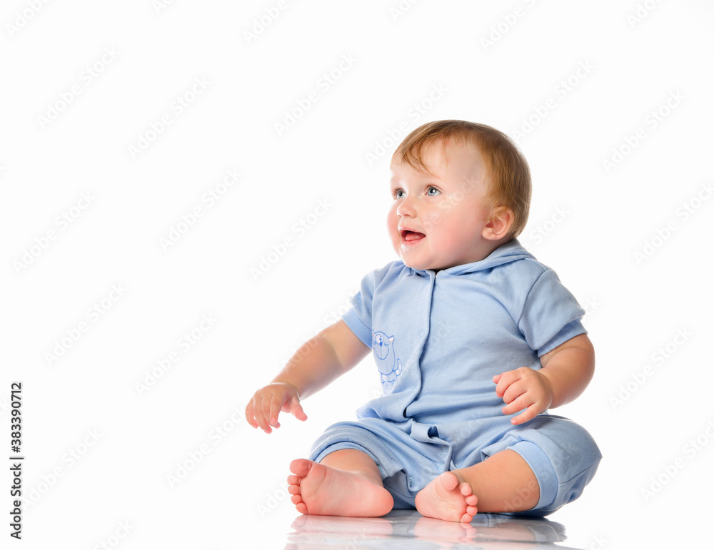 Little boy in a pajama bodysuit is playing in the studio on a white background. Little boy in a pajama bodysuit is playing in the studio on a white background.
